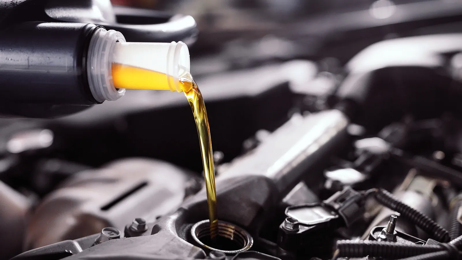 Fresh engine oil being poured into an engine